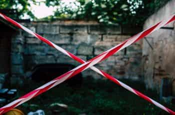 White and red tape block a courtyard.