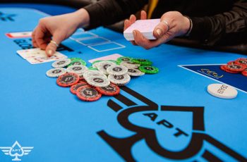 Dealers hands a flop at a poker table.